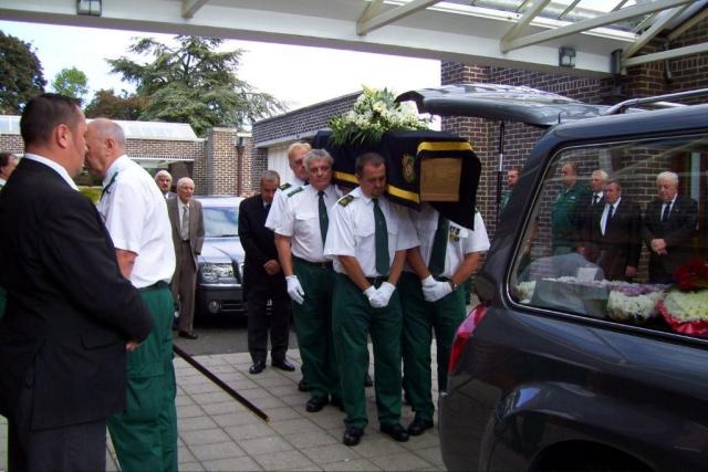 Service Personnel Carry the Coffin into the Chapel.